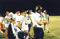 Johnny DeLa Zerda and Kyle Dockery watch from the sidelines