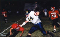 Greg Richter stiff arms a bulldog