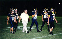 Coach Bonewald  talks to the Pirates after a score