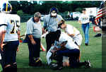 Coach Bonewald looks after an injured Pirate's finger