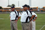 Coach Selph and other coaches watch the action