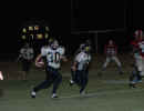 Willie Fluitt, with blockers, runs in the open field