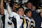 Steven Hernandez celebrates victory with teammates and cheerleaders